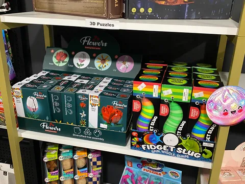Shelf display of sensory fidget toys including fidget slugs, squishies, and stress-relief items at Mindspace Toys.
