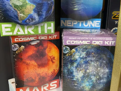 Cosmic Dig Kit space-themed STEM excavation kits on display at Mindspace Toys, featuring Mercury, Neptune, Earth, and Mars.