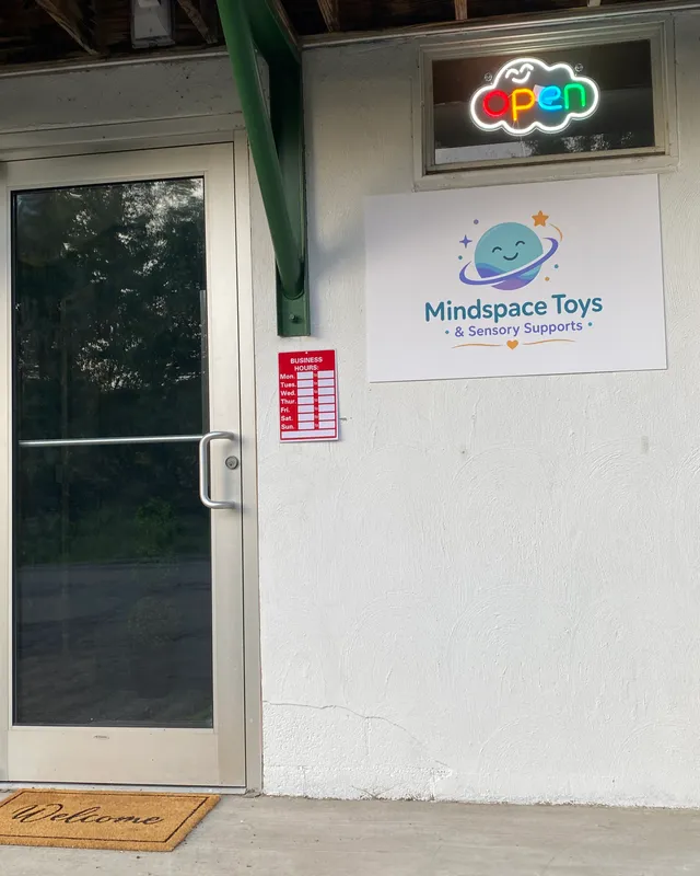 The Mindspace Toys & Sensory Supports storefront entrance in Clarks Summit, PA, with the door open sign lit and a welcome mat out front.